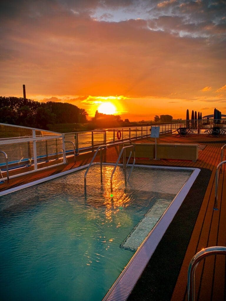 The sundeck pool of AmaLucia at sunset on the Rhine.