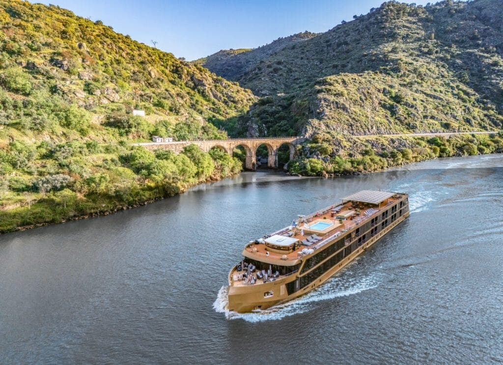 AmaSintra cruising toward an old stone bridge on the Douro.
