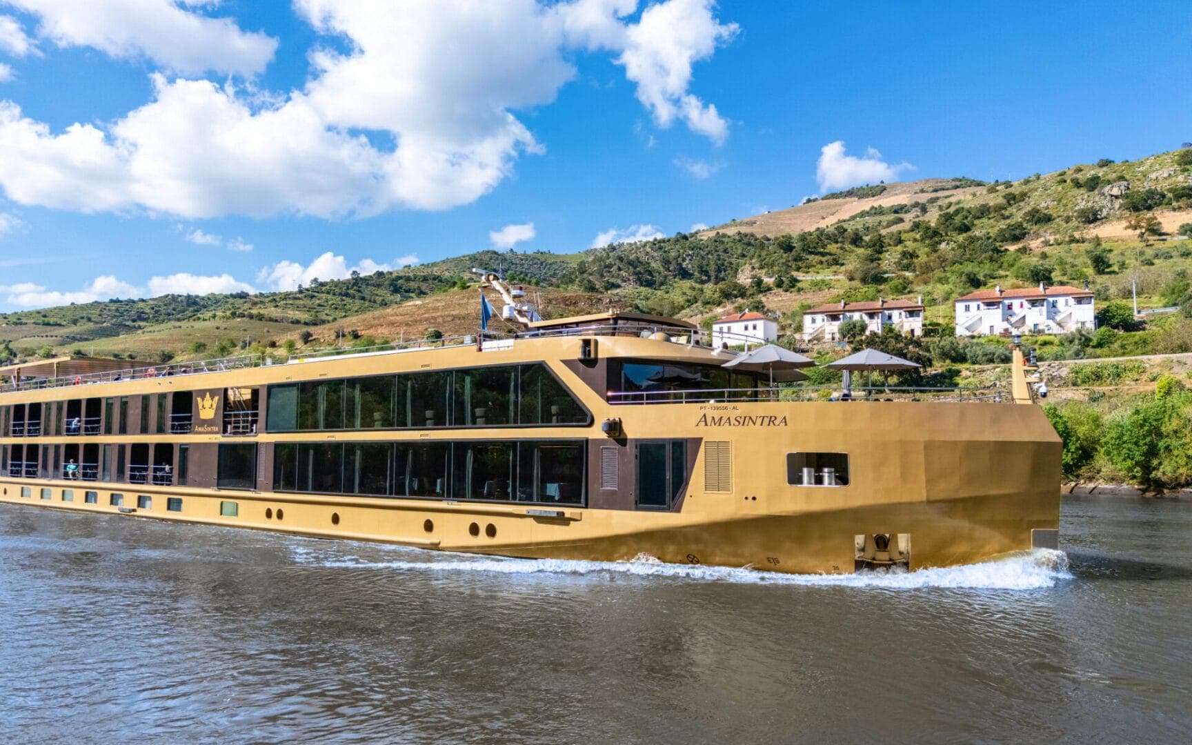 AmaSintra's golden hull in profile on the river.