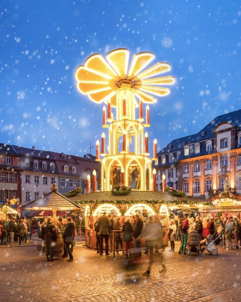 A lit Christmas pyramid in the Heidelberg market square.