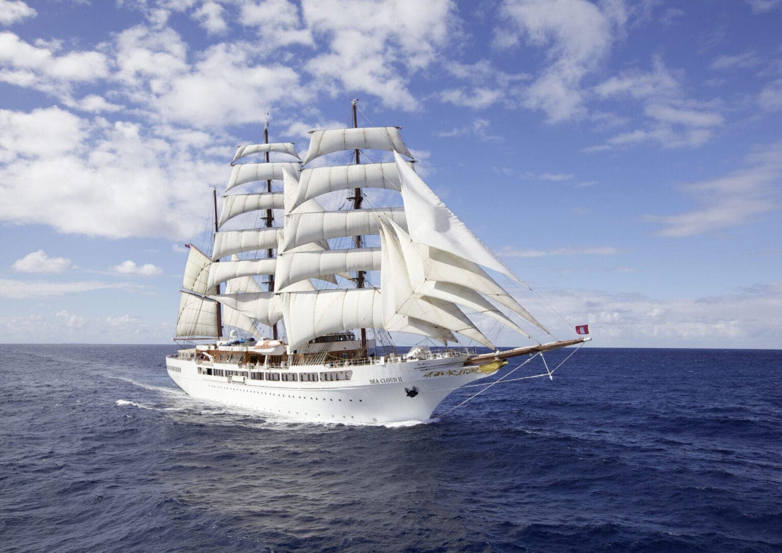 SEA CLOUD II under full sail on open water, every square sail set.
